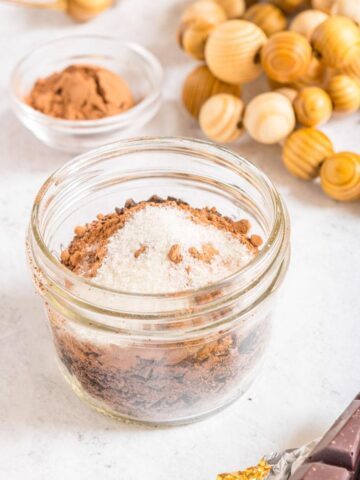 3 ingredient dark hot chocolate mix in glass jar with more ingredients in background
