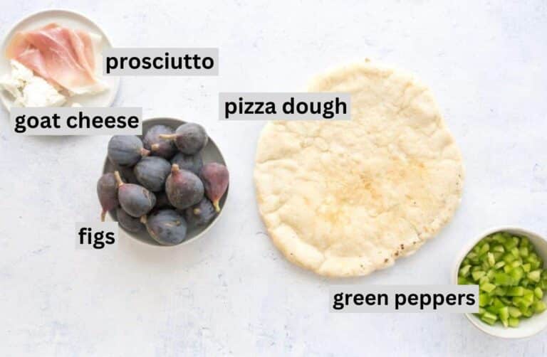ingredients for pizza with fig and prosciutto on a table