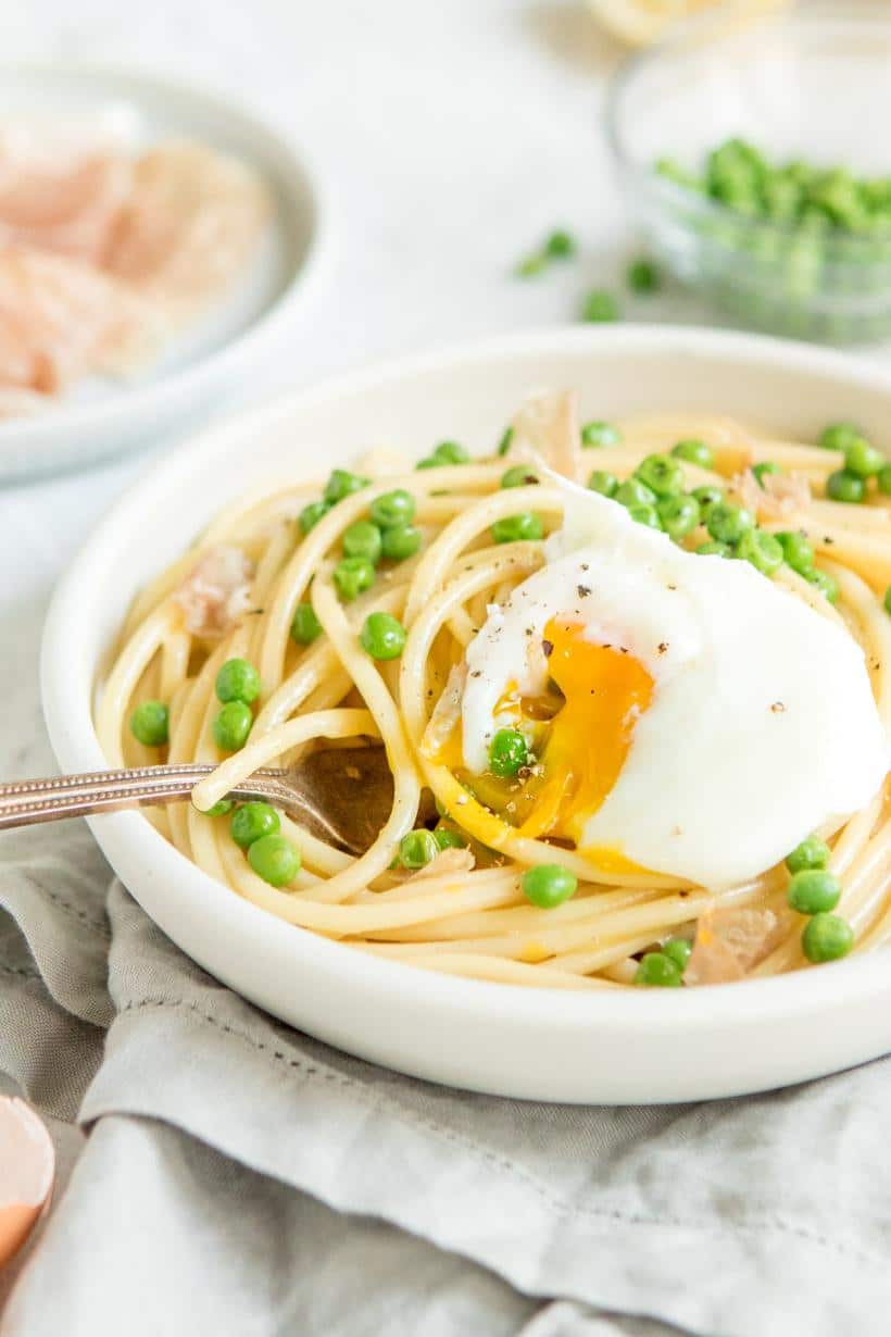 eggs in a bowl with an egg carton in the background