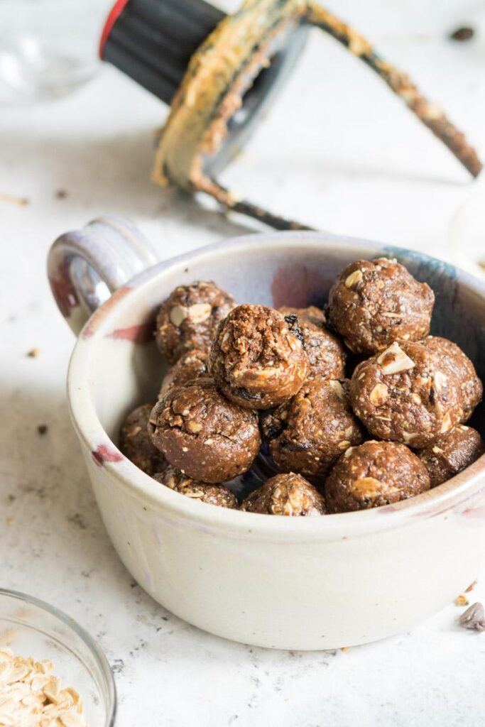 energy bites in a bowl with yogurt