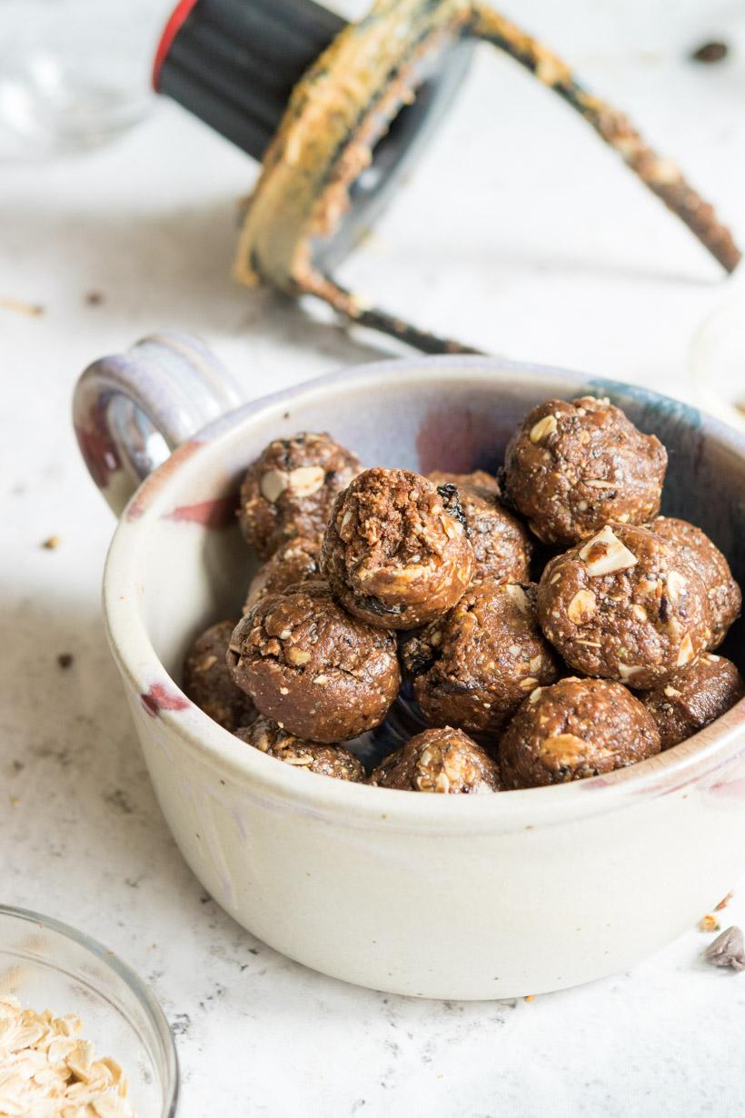 energy bites in a bowl with blender lid in background