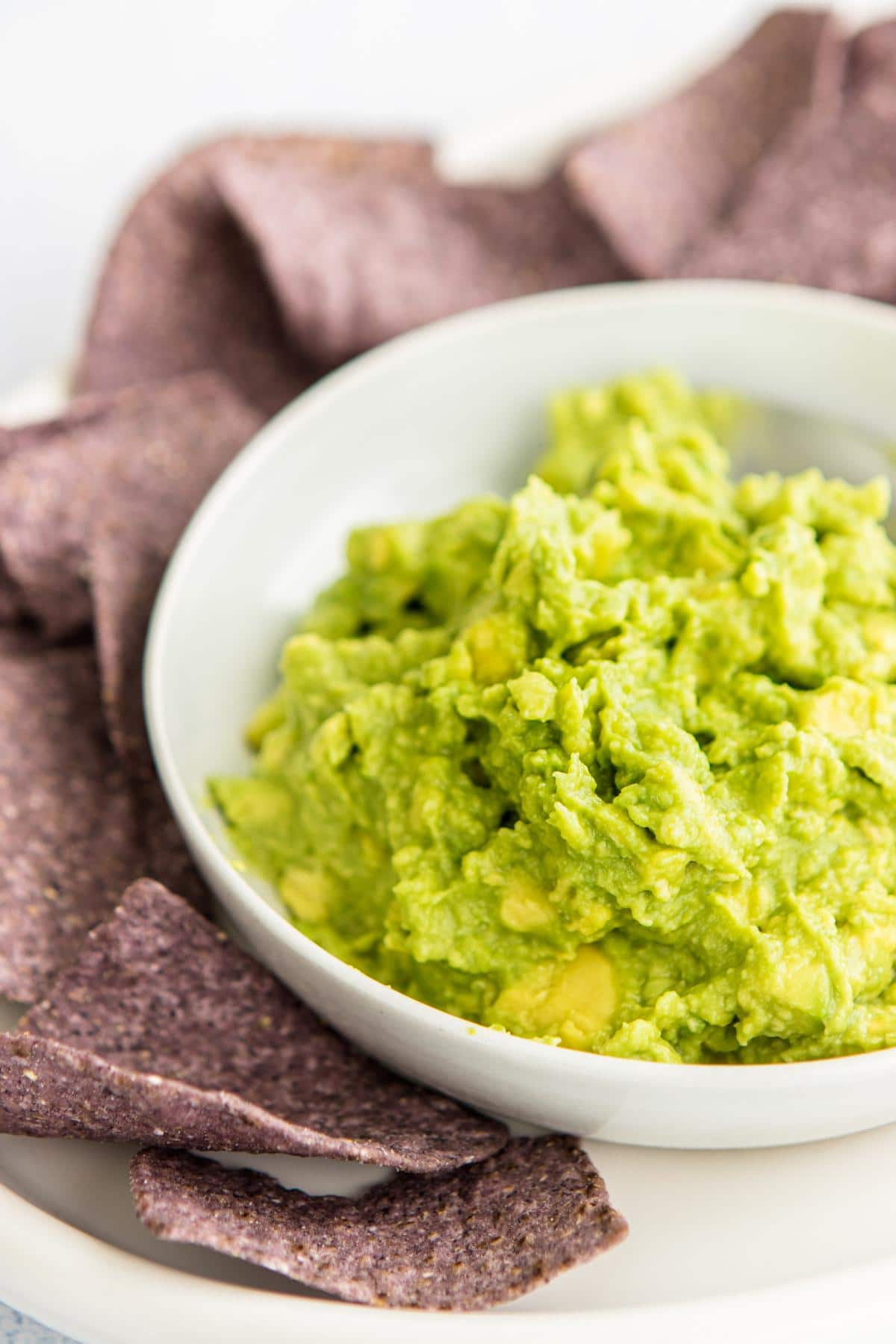 tortilla chips with 4 ingredient guacamole in wooden bowls