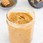 honey almond butter with salt on top in a glass jar on table