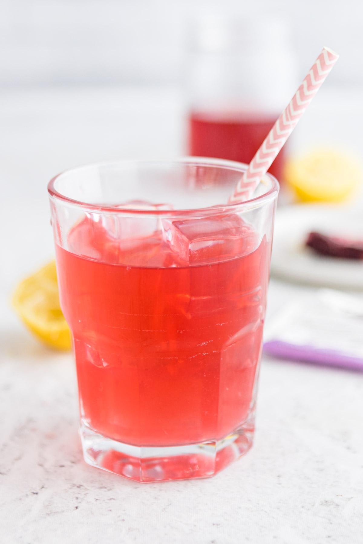 passion tea lemonade in a glass with a straw