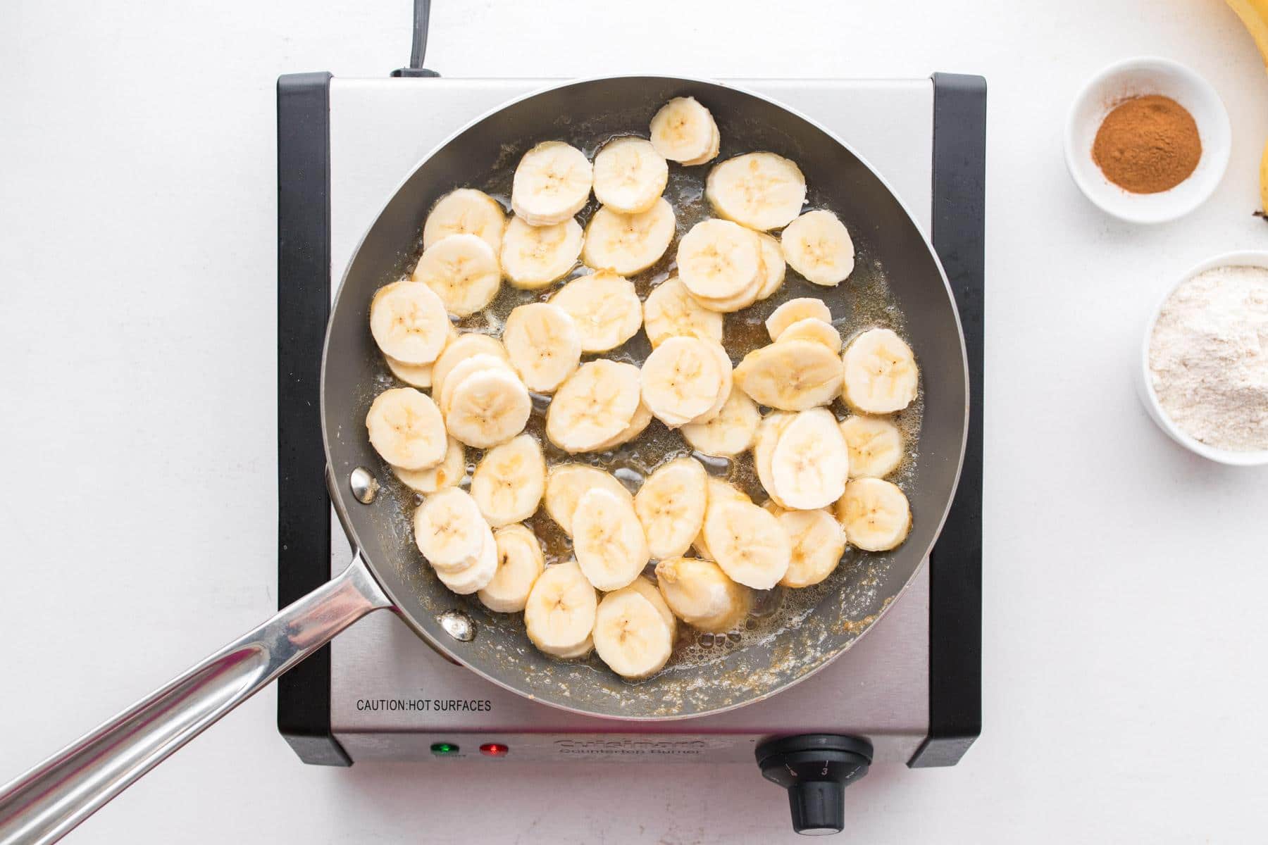 sliced bananas cooking in caramel