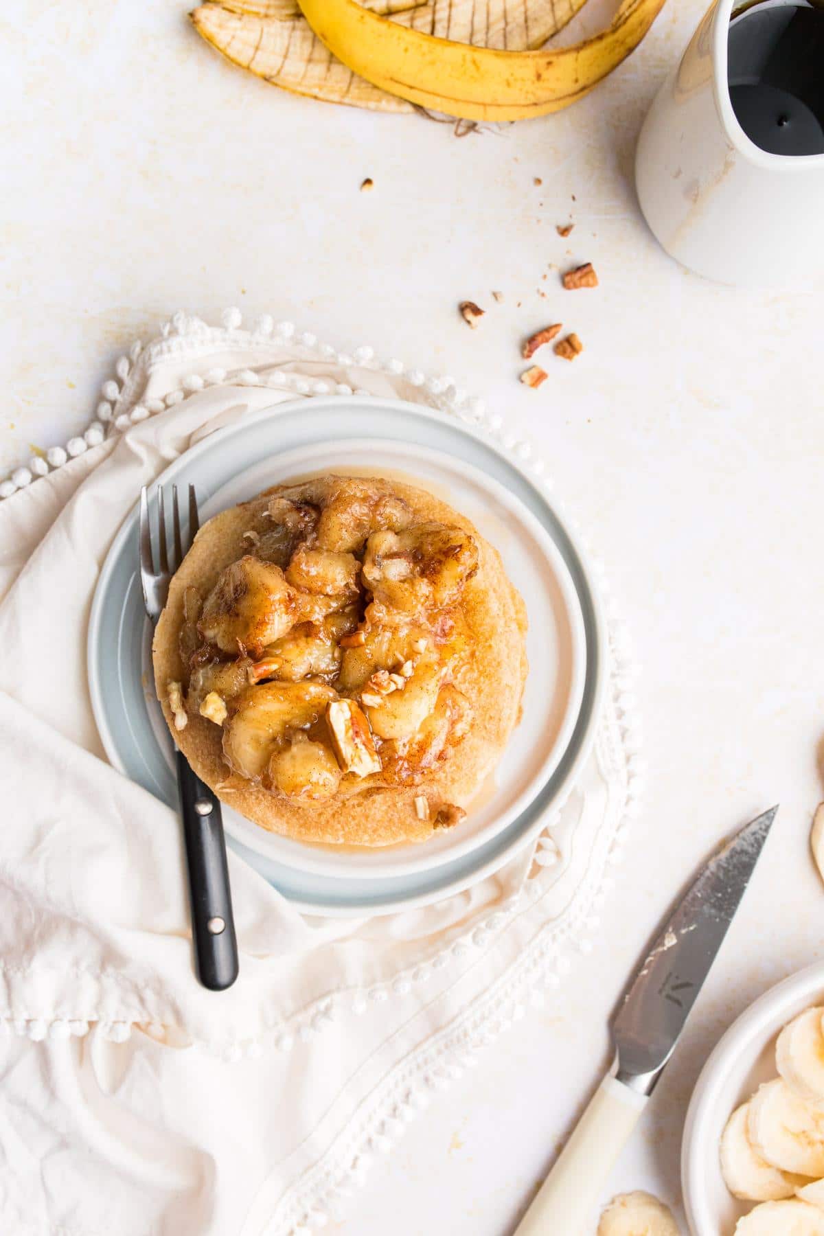 a stack of pancakes with a sauteed banana topping