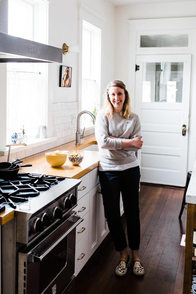 Rebecca, a cooking for one dietitian and eating disorder nutritionist, standing in kitchen