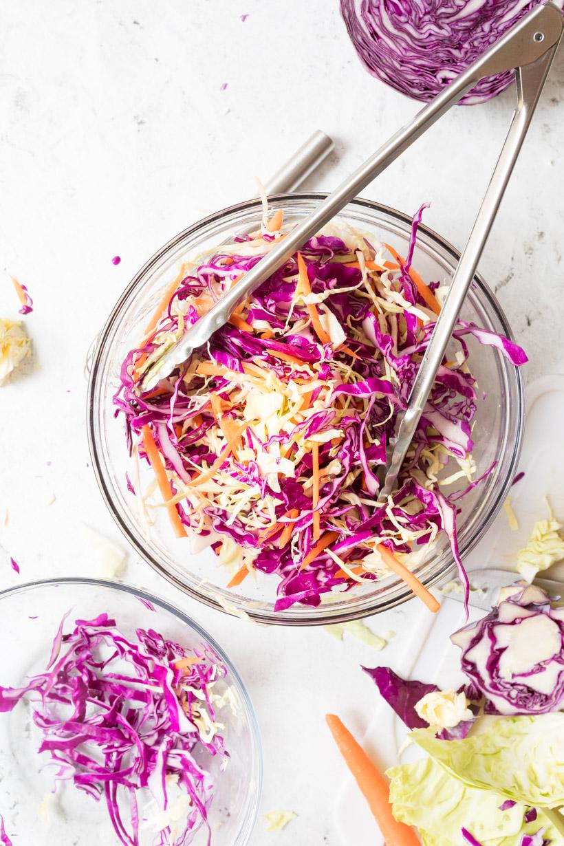 rainbow coleslaw in a yellow bowl