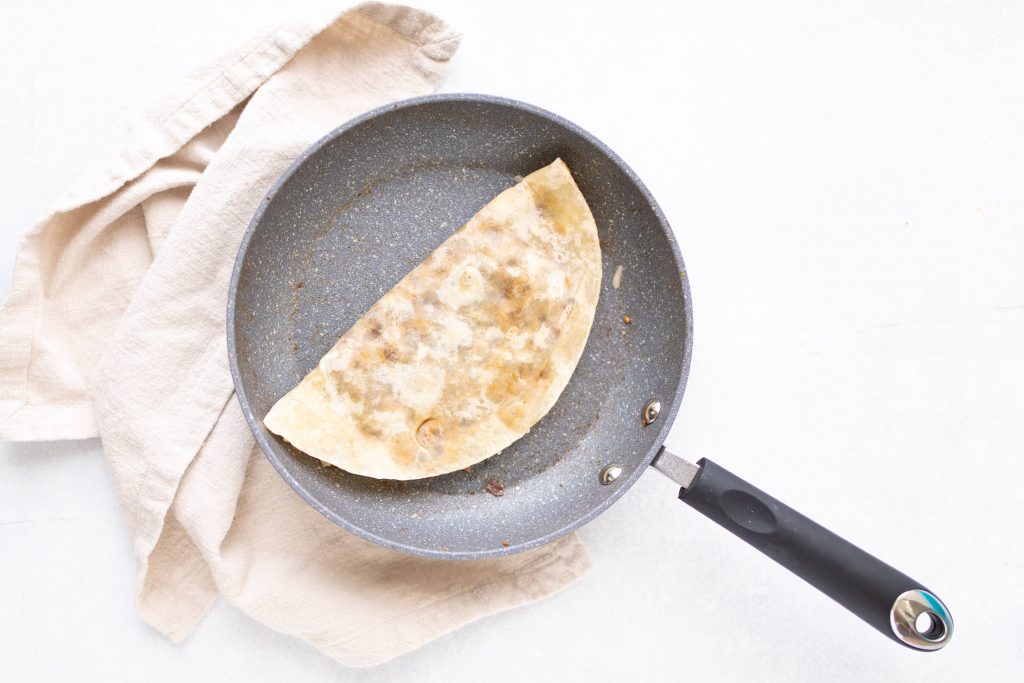 folded vegetarian quesadilla in sautee pan