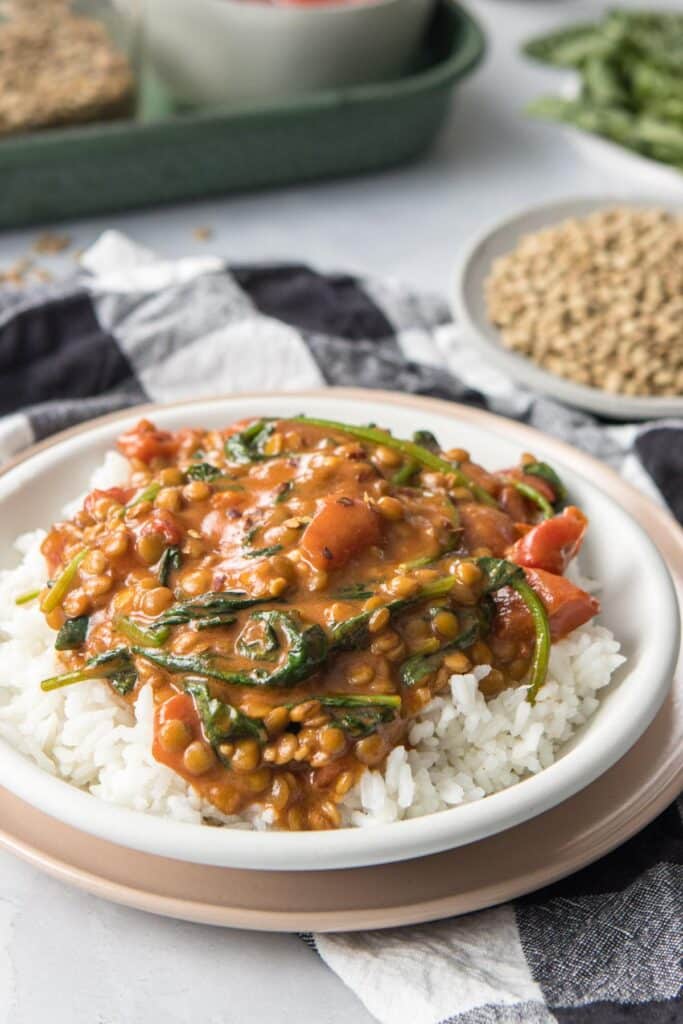 close up of green lentil coconut curry in a bowl