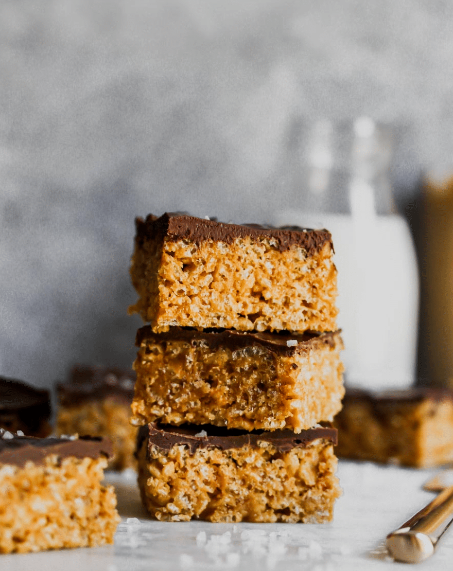 a stack of peanut butter crispy rice treats with chocolate on top