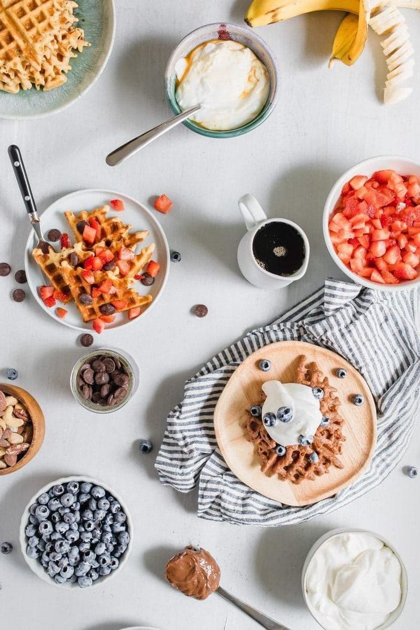 waffles, fruit, and sauces on plates