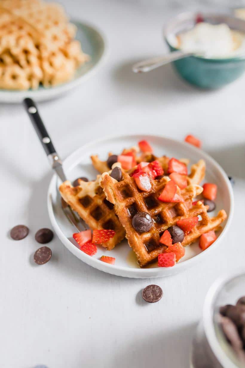 Waffles with strawberries and chocolate chips on a plate