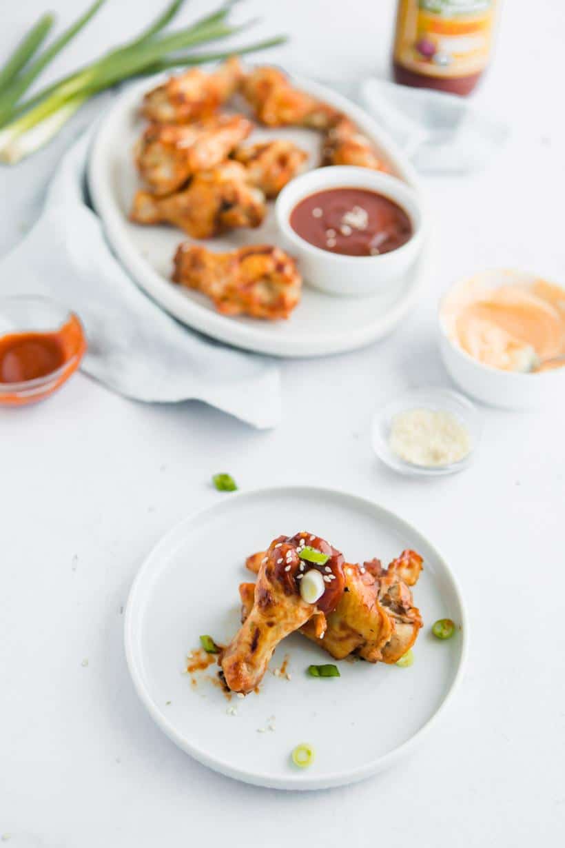 Asian BBQ Chicken Wings on a plate with more in background