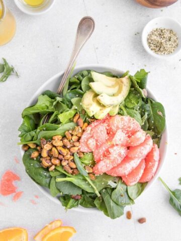 grapefruit and avocado salad in a bowl with a fork