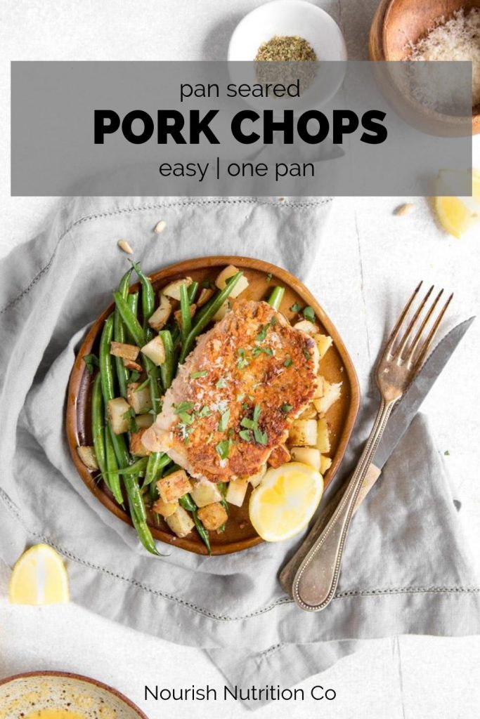 pan seared pork chops with vegetables on a plate with text overlay