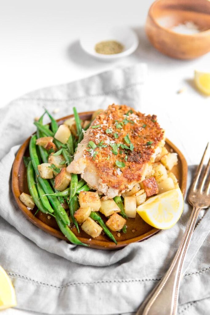 Pan seared pork chops with green beans and potatoes on a plate