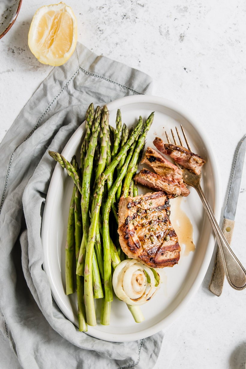 grilled lamb steak with asparagus on a plate