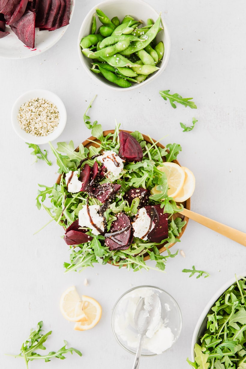 beet, arugula, goat cheese salad on plate