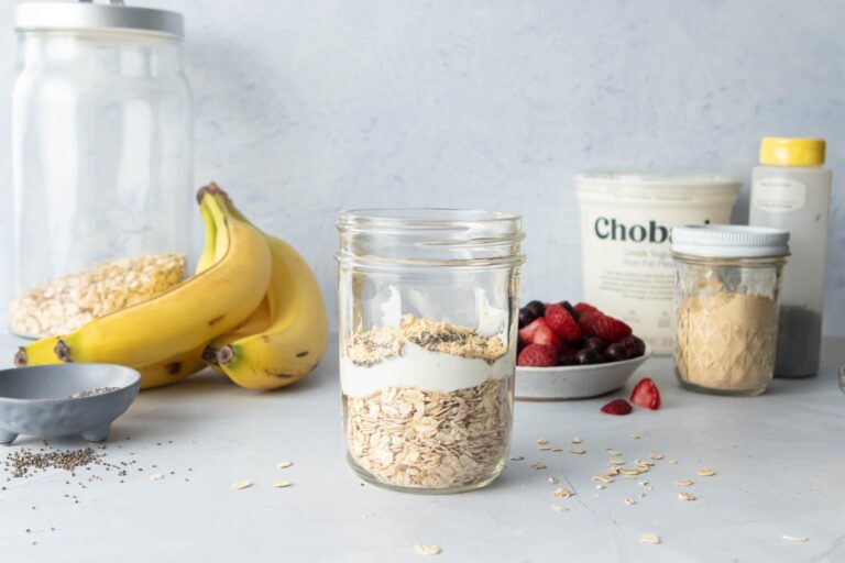 oatmeal and Greek yogurt in a jar with other ingredients surrounding it