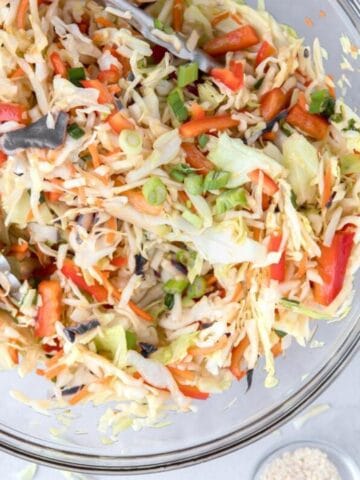 close up of Asian slaw in a glass bowl