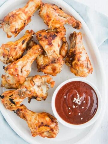 close up of chicken wings with Asian BBQ sauce on a plate