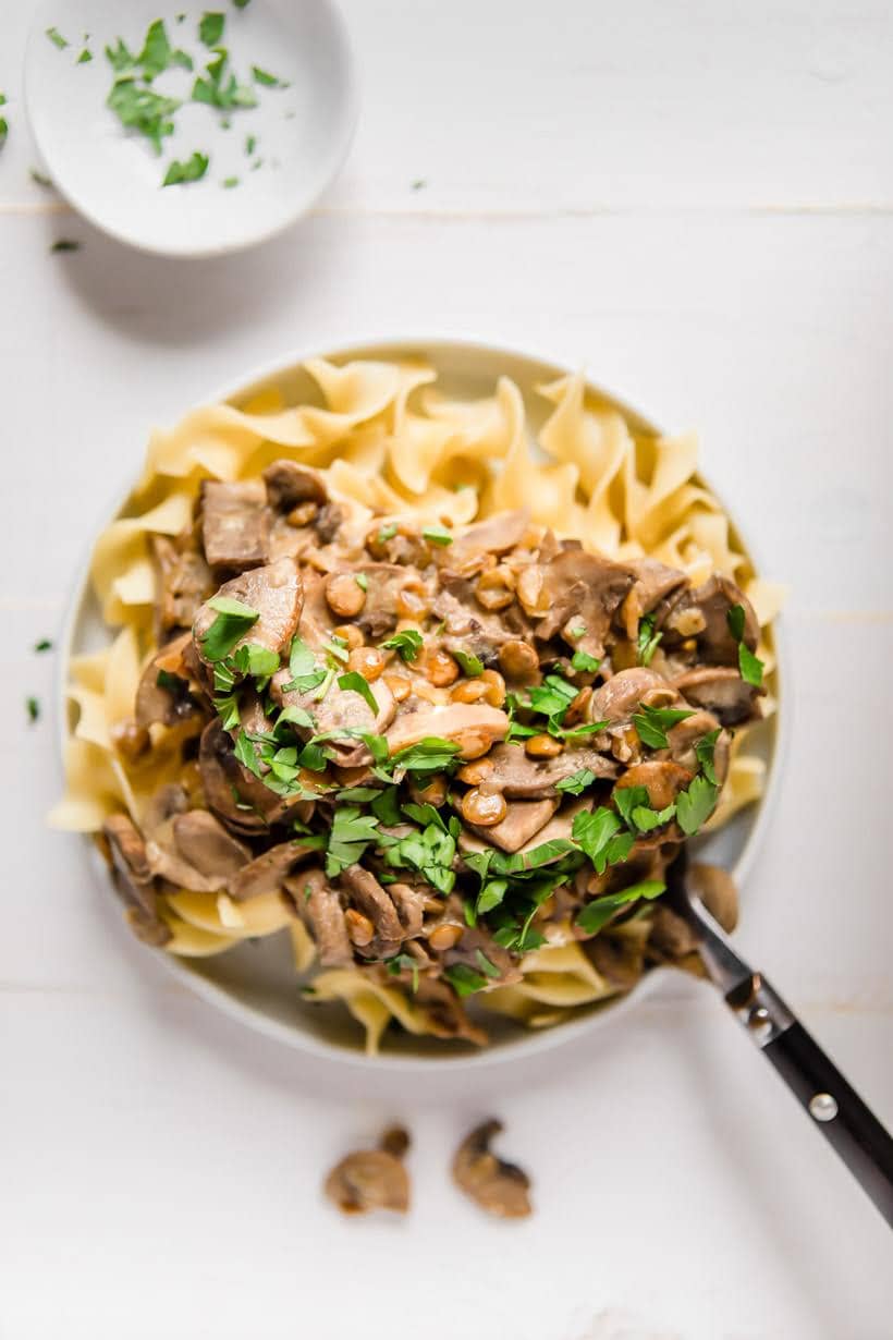 Instant Pot lentil stroganoff on a plate with parsley on top