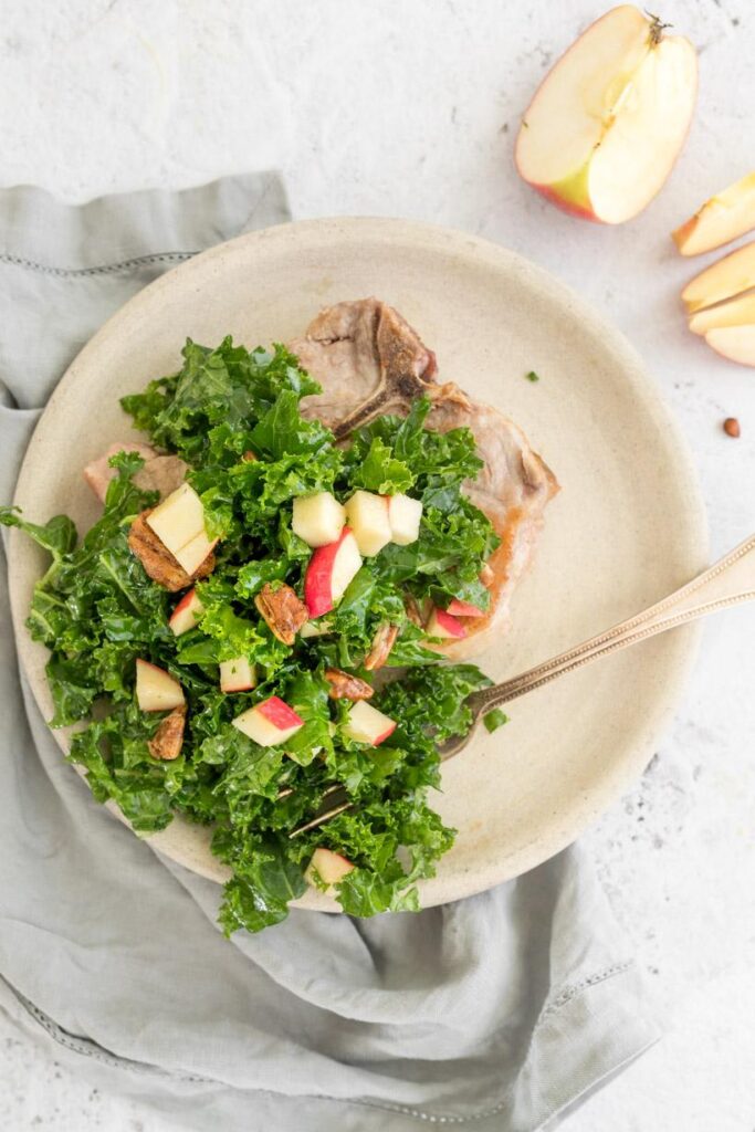 kale, apple and pecan salad on a plate