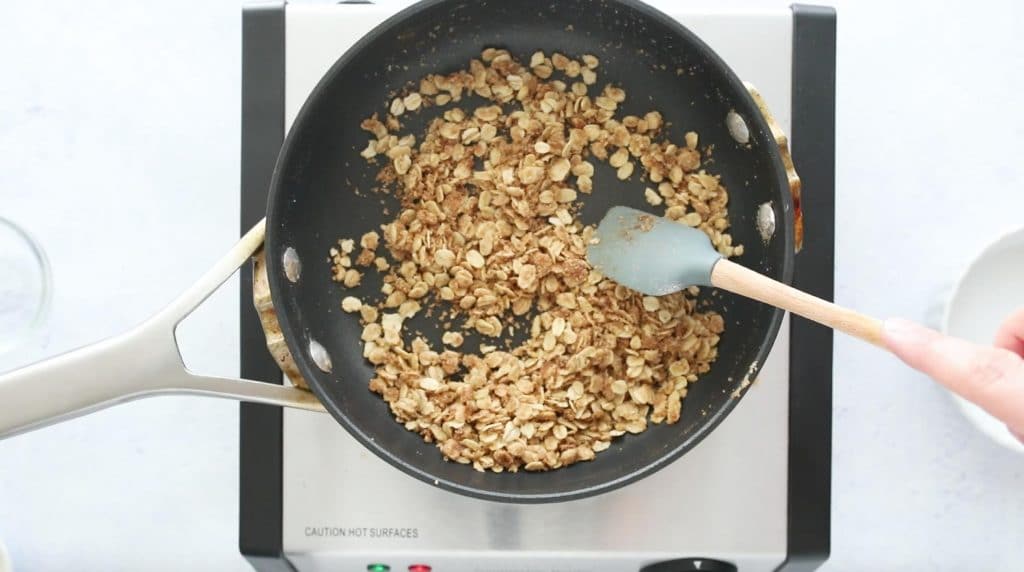 cooked oats with butter and sugar in pan