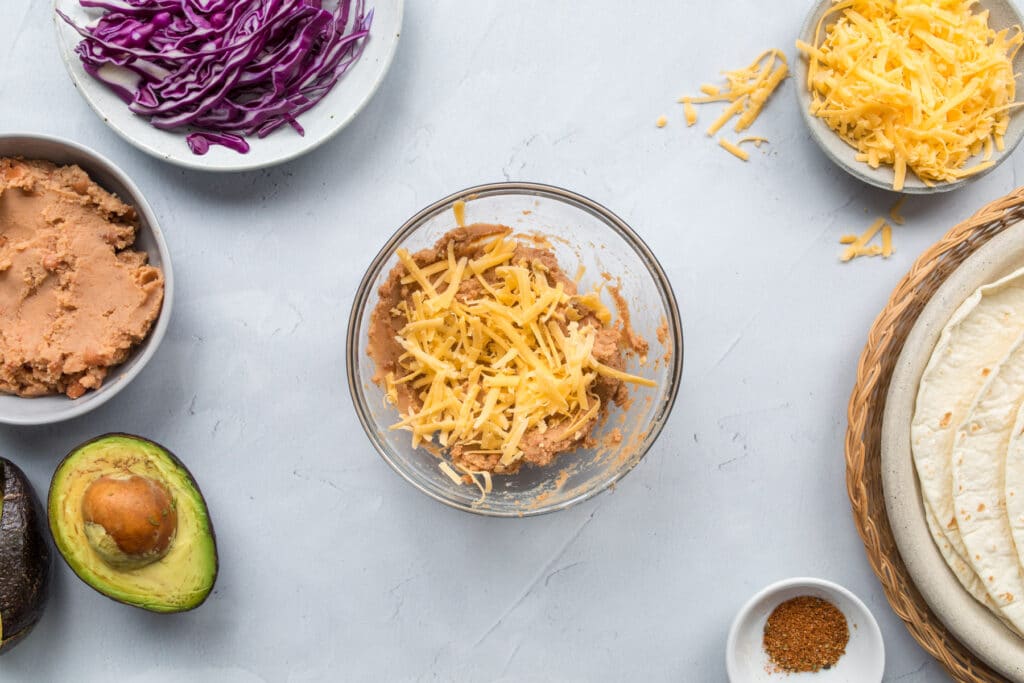 bowl of refried beans with cheese on top