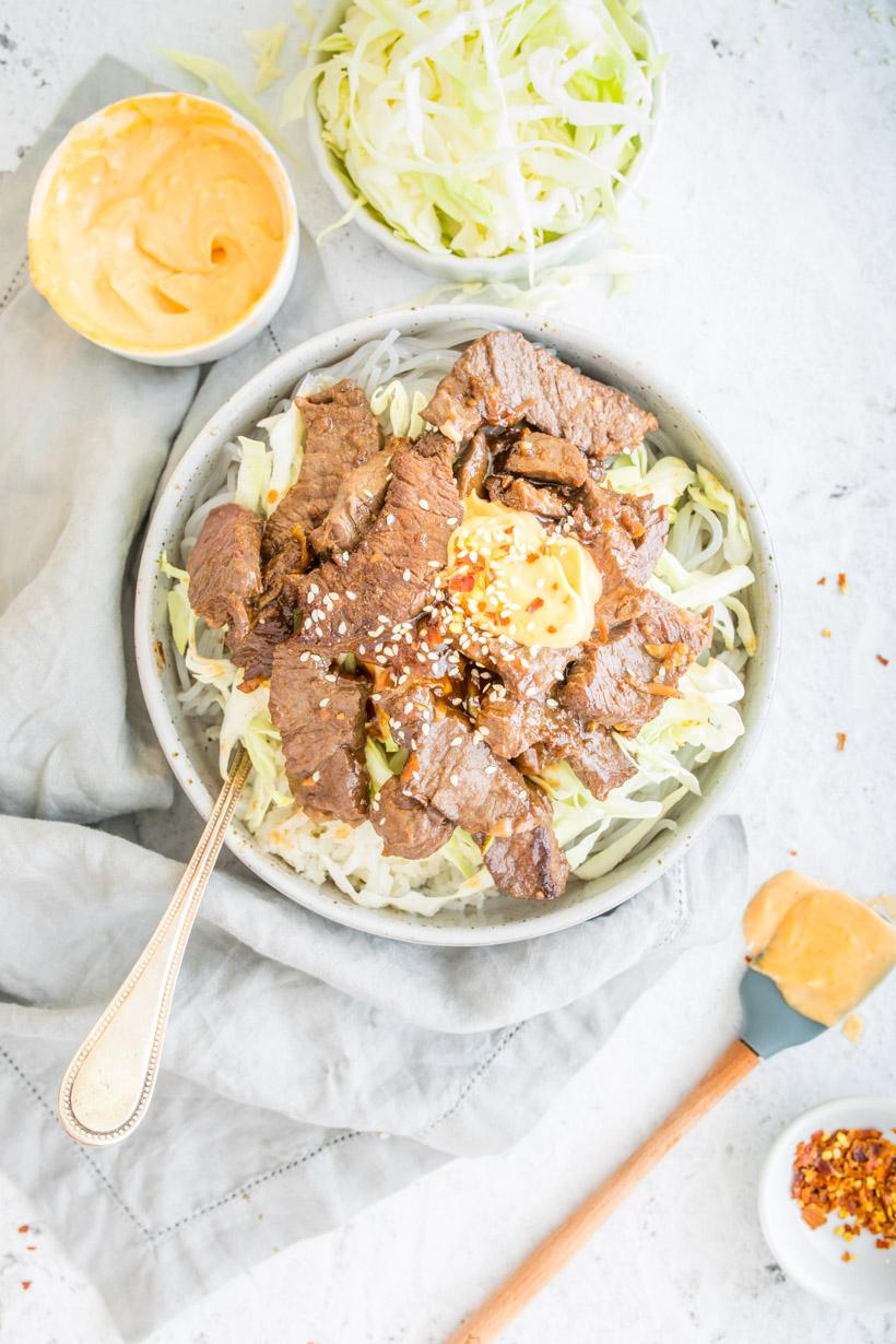 Korean Bulgogi on a table with sauces