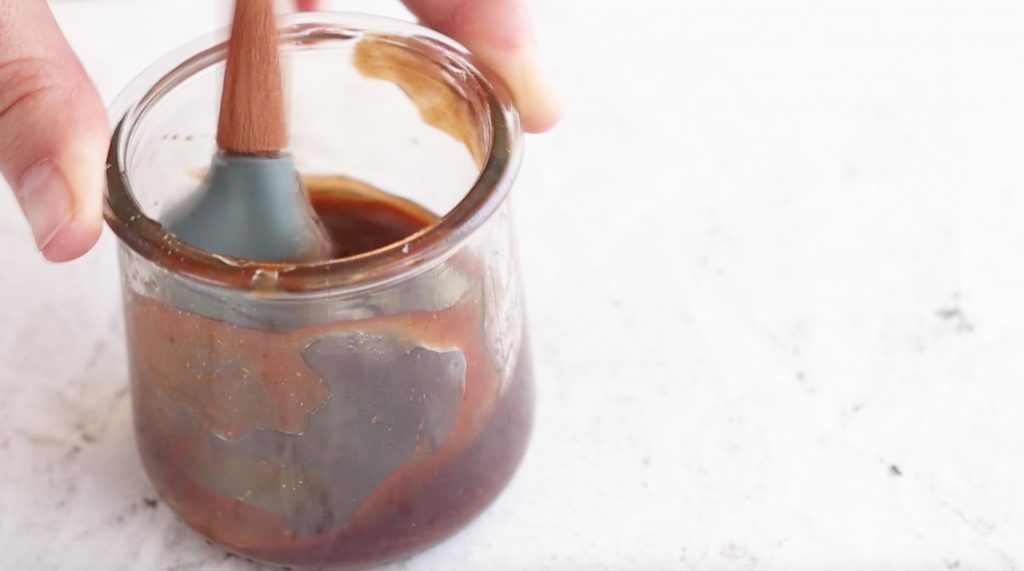 mixing Korean BBQ sauce in a small glass jar