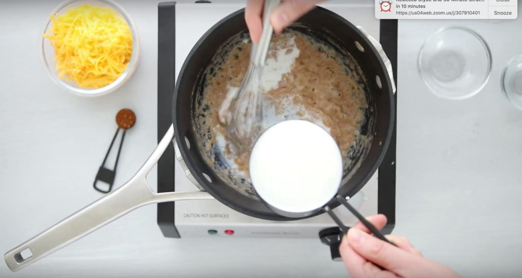 pouring milk into flour and butter