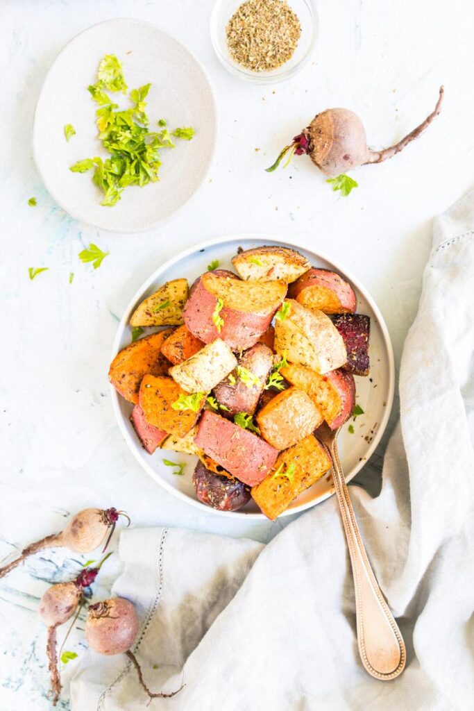 roasted winter vegetables on a plate with ingredients surrounding it