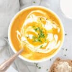 bowl of pumpkin soup with cream and chives