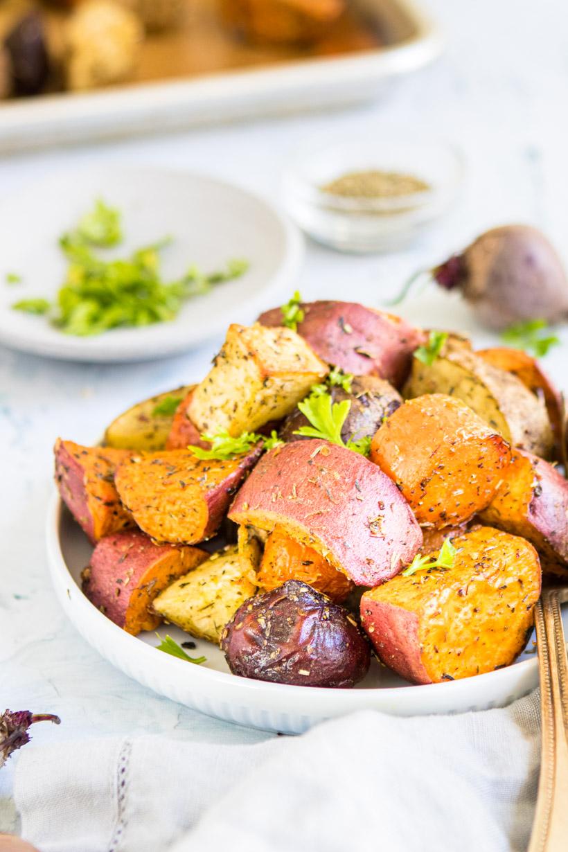 roasted winter vegetables on a plate with ingredients in the background