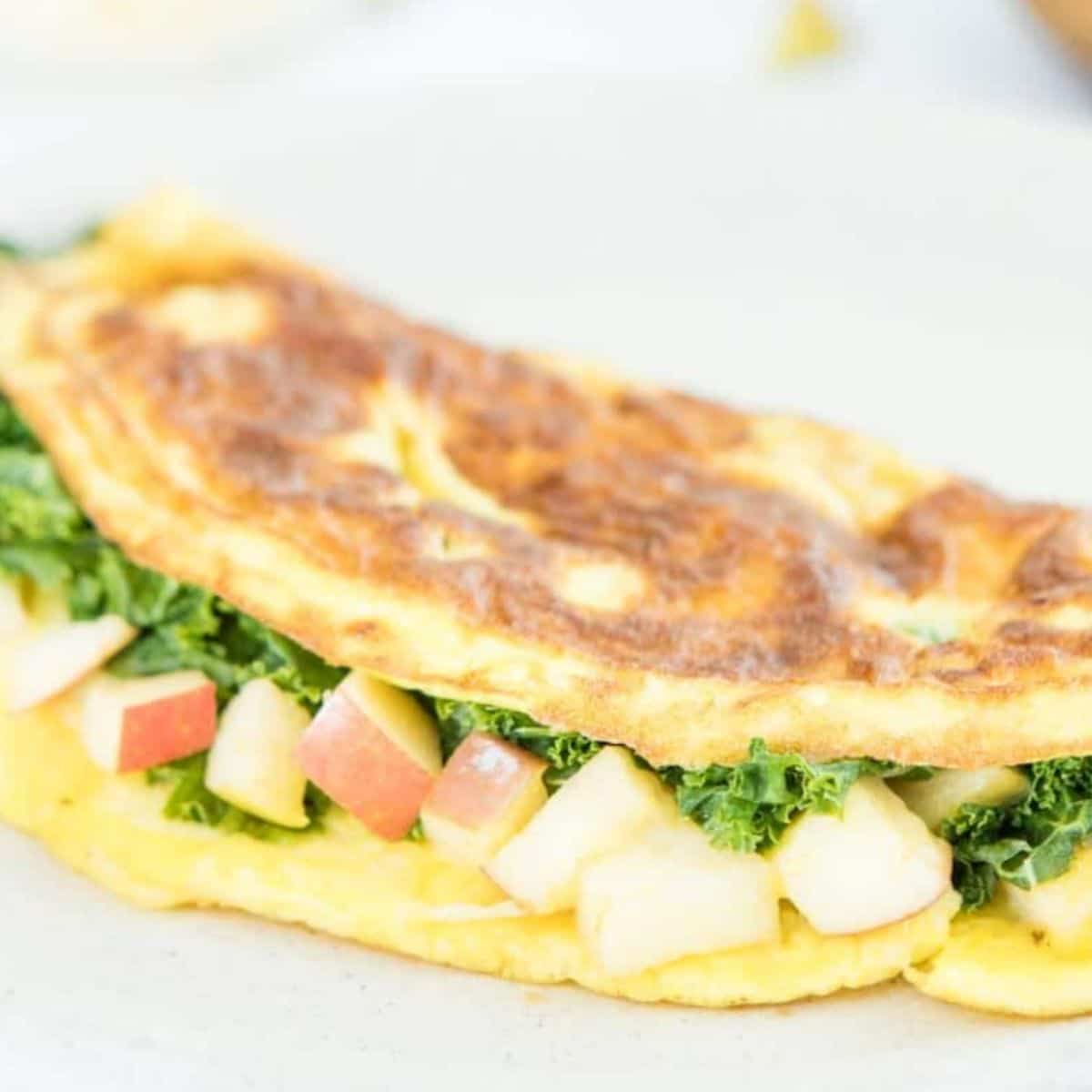 omelet with chopped apples and kale inside