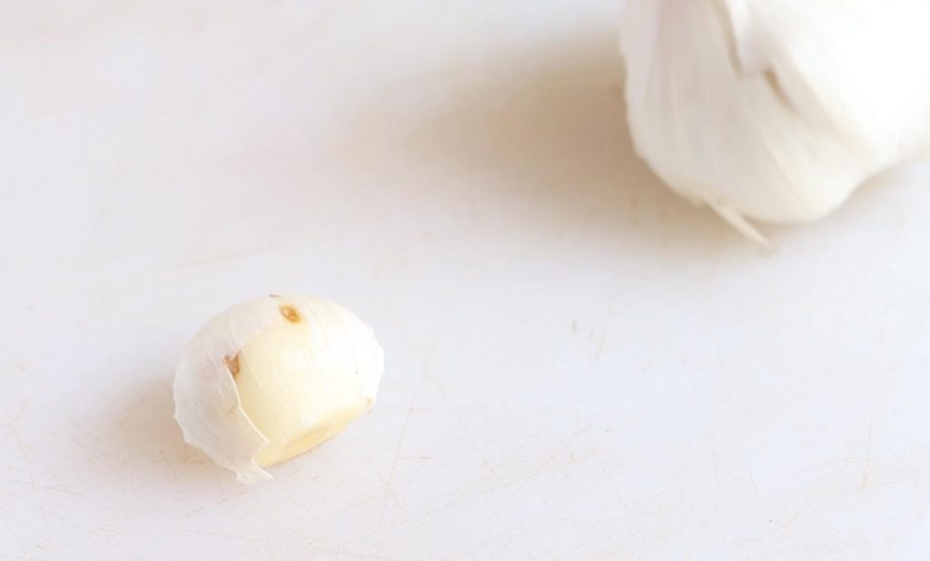 garlic clove with the end cut off