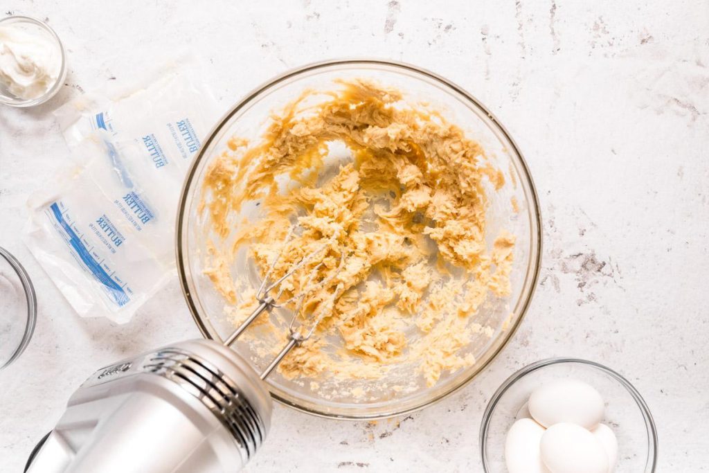 creamed brown sugar and butter in a glass bowl with hand mixer