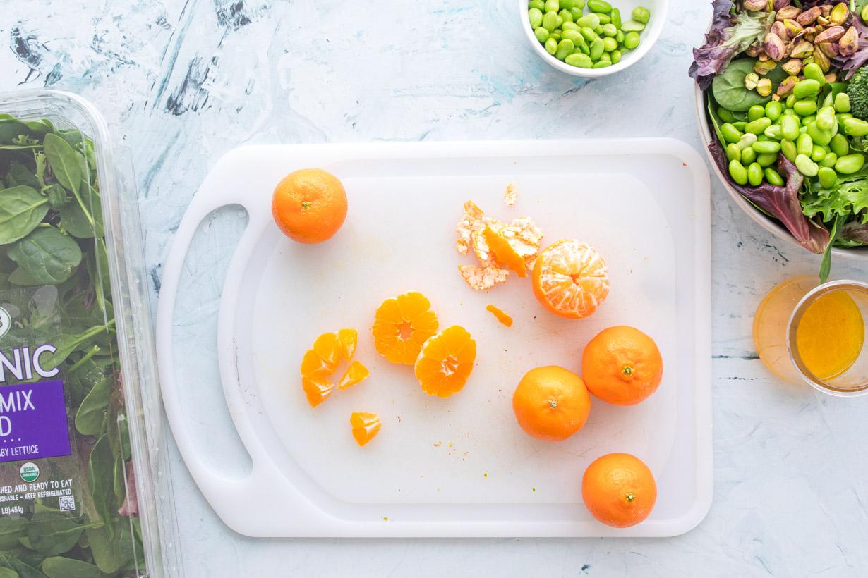 peeled and sliced mandarin oranges on a cutting board