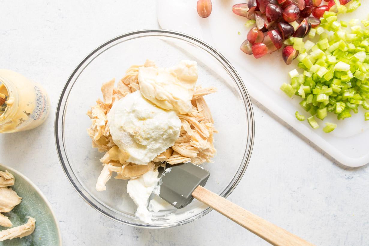 chicken, mayonnaise, and Greek yogurt in a glass bowl