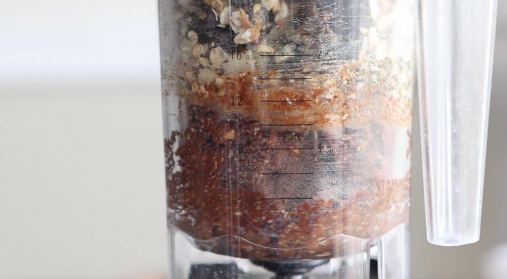 blending ingredients for protein energy balls in a blender bowl