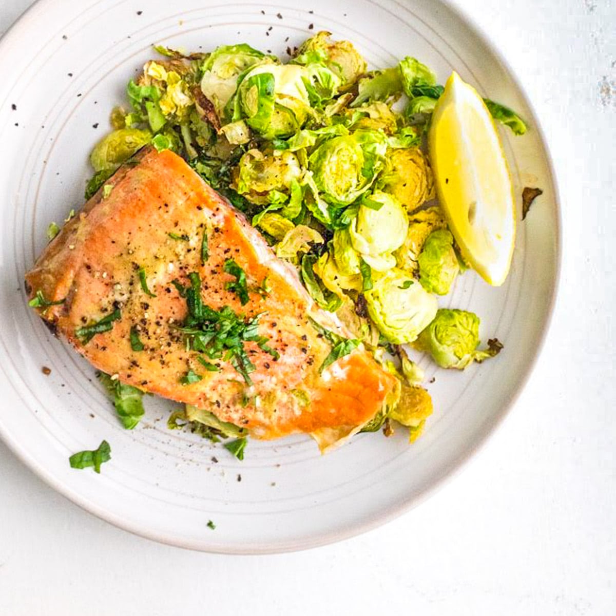 maple mustard salmon and brussels sprouts on a plate