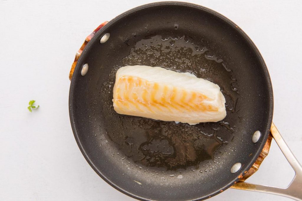 tilapia filet in a small fry pan