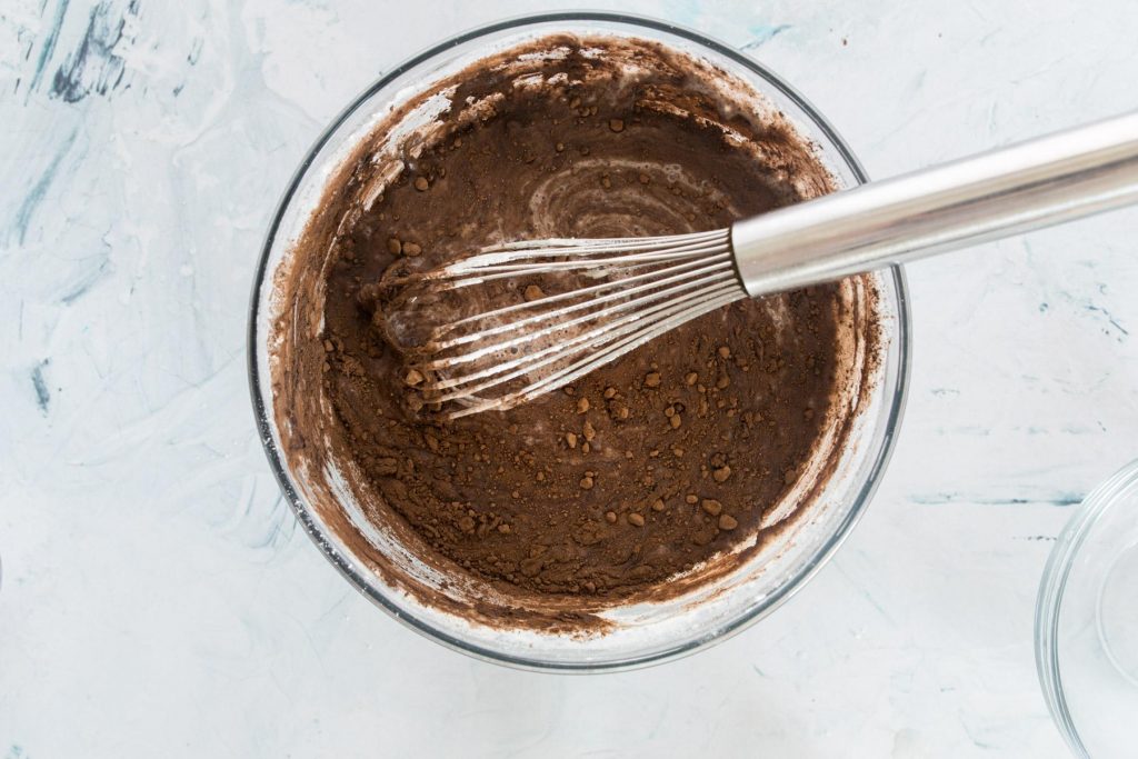 dark chocolate waffle batter in a glass mixing bowl