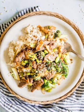 sliced beef, broccoli over rice on plate