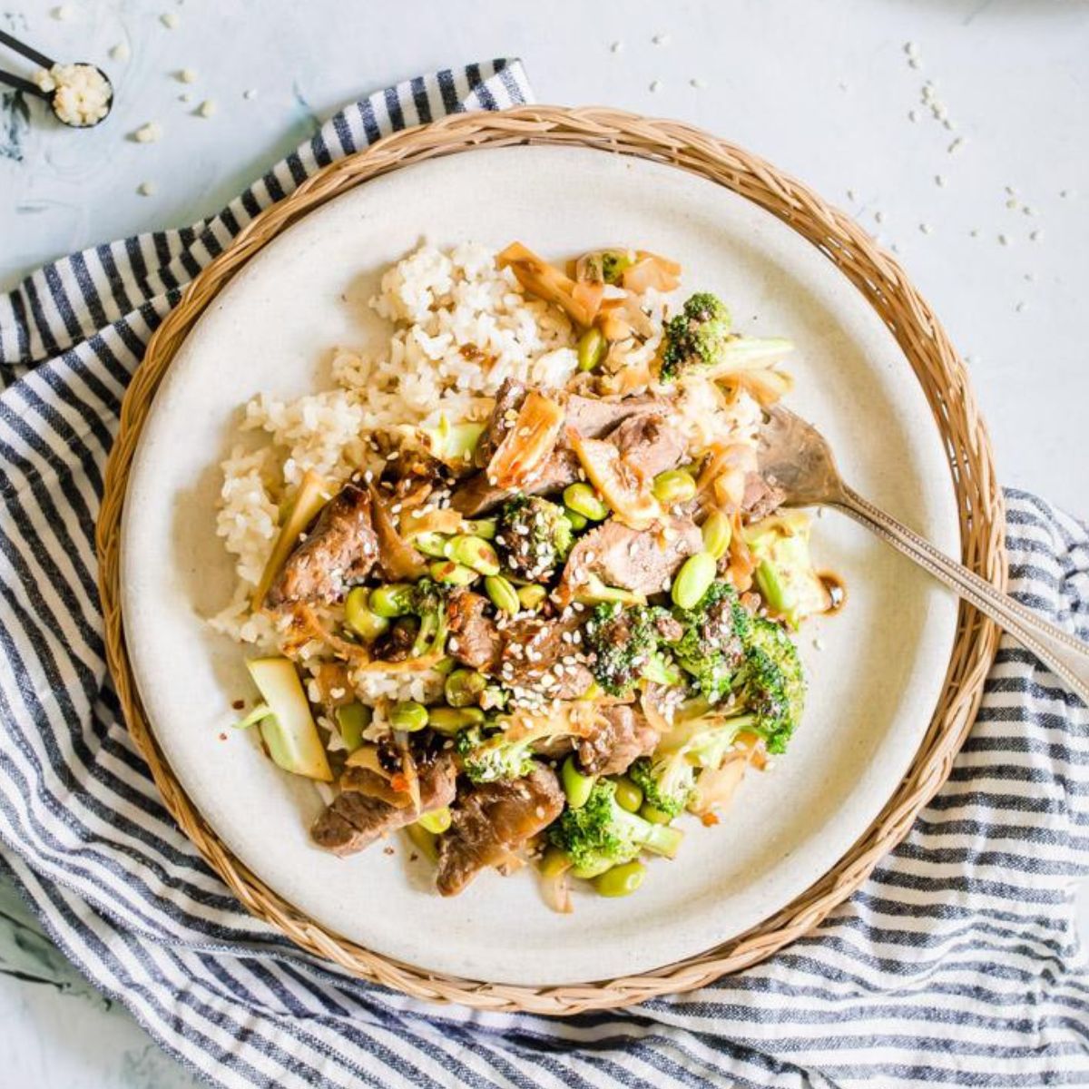 sliced beef, broccoli over rice on plate