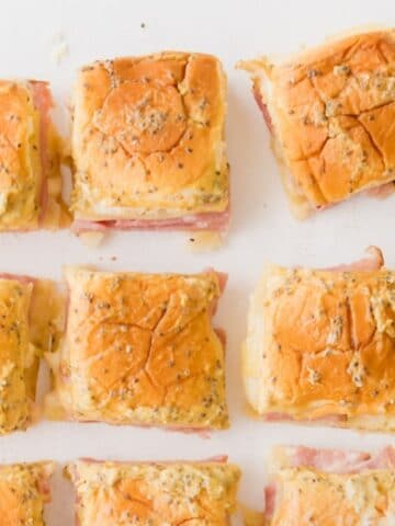 ham and swiss sliders on Hawaiian rolls on a table