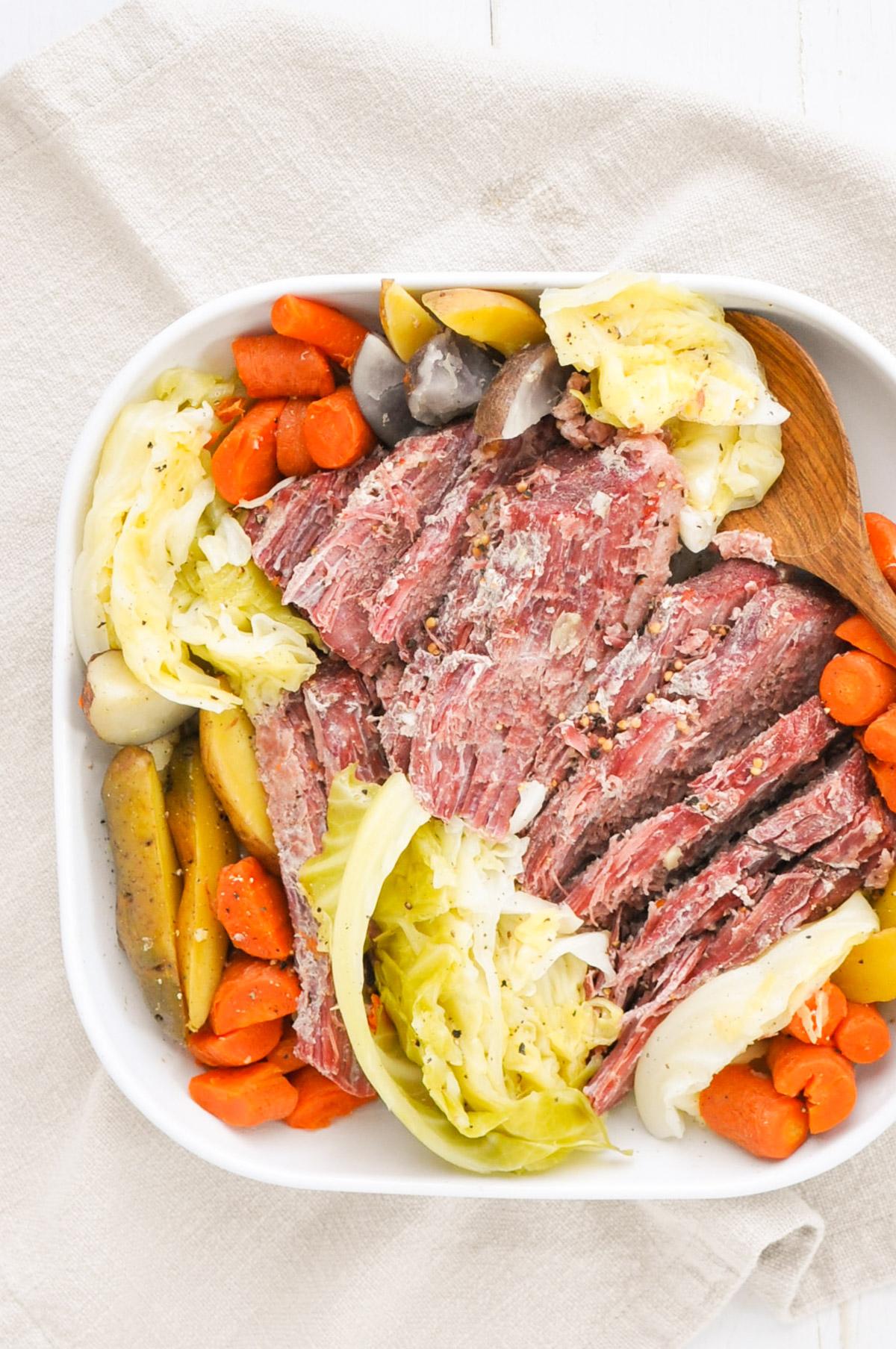 corned beef, cabbage, potatoes, and carrots on a white plate