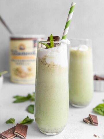 square photo of a shamrock shake with ingredients in background